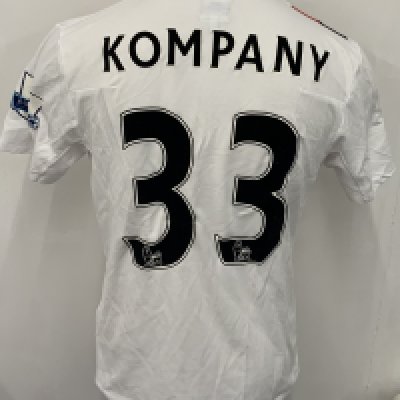 Manchester City 2009 - 2010 Kompany 3rd Kit Match Worn Football Shirt: White with red and black slash short sleeve Umbro shirt from 1st season of Etihad Sponsorship. Premier League badging to sleeve and Kompany 33 to rear. 