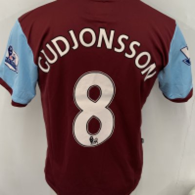 Burnley 2009 - 2010 Match Worn Football Shirt: Claret and blue short sleeve shirt. Number 8 Gudjonsson. Premier League badging. Worn v Arsenal on 16 December 2009. Match finished 1-1.