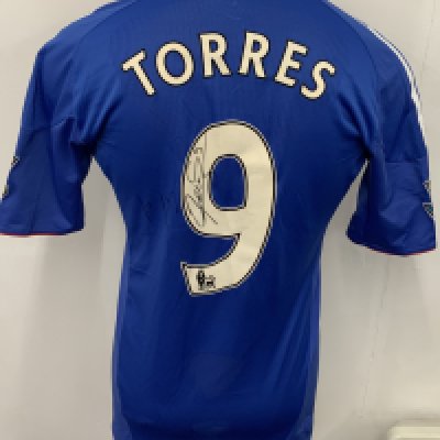 Chelsea 2010 - 2011 Match Worn Torres Football Shirt: Blue short sleeve home shirt with Gold Premier League sleeve badging stating Champions 09/10. Signed to rear with dedication. Number 9 Torres to reverse. 