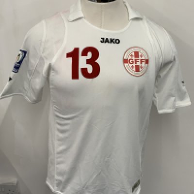 Georgia 2010 Match Worn Football Shirt: White short sleeve shirt. Number 13. Worn by Khizanishvili v Cyprus in World Cup qualifier on 28 March 2009. World Cup badge to sleeve. Some staining from red numbers when washed. 