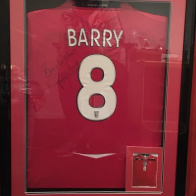 2008 Gareth Barry Match Worn England Framed Football Shirt: Red away  shirt with number 8 Barry to rear. Signed best wishes Gareth Barry next to number 8. Expensively framed in deep frame. Plaque at the bottom states England Shirt Match Worn By Gareth Barry France 1 England 0 26 3 2008. Not for posting. 