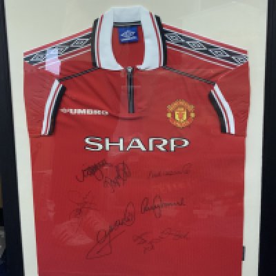 Manchester United 1998 - 1999 Treble Winners Signed Framed Shirt: Signed by seven players including Beckham. Frame measures approximately 38 inches by 31 inches. Original home shirt from the day. No COA. Not for posting. 