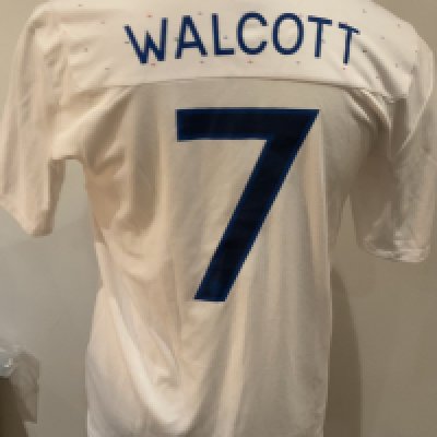 England 2011 Match Worn Football Shirt: White short sleeve shirt with Walcott 7 to rear. Worn in the match v Denmark on 9 February 2011.