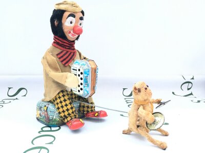 A Vintage Alps (Japan) Tinplate Battery Operated Accordion-Playing Clown With A Cymbal-Playing Monkey.