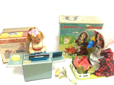 A Boxed Japanese Tinplate Battery Powered Miss Friday The Typist And A Lady Pup Tending Her Garden A/F. (2).