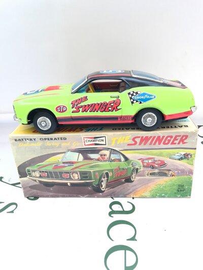 A Boxed Japanese T.R.S. Battery Operated Racing Car The Swinger.