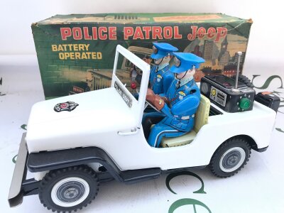 A Boxed Vintage Japanese TN Nomura Battery Operated Police Patrol Jeep.