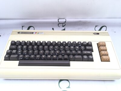 A Commodore Vic 20 Keyboard, A C2N Datasette Unit And Cartridges.(2).