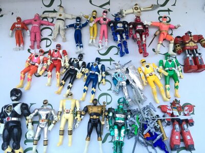 A Collection Of Power Ranger Figures And Accessories.