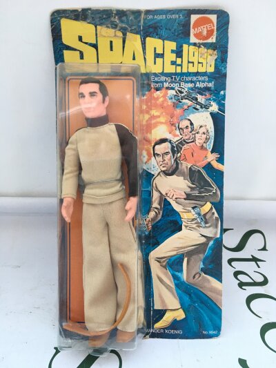 A Mattel Carded Space 1999 Commander Koeimg. Blister has Damage and may have been pit back on.