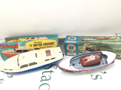2 Boxed Clockwork Boats. A Tri-Ang 11” Motor Cruiser And A Scalex Boats Lifeboat, Parts Missing, Boxes Worn. No Reserve.