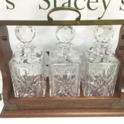 A reproduction three bottle tantalus. Shipping category D.