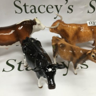 A collection of four Beswick cows including Highland Cattle.