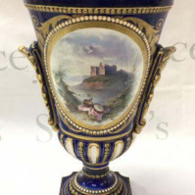 A Sevres style cobalt blue and gilt vase hand painted with panels of classical figures and a castle view. 34cm high, this lot cannot be posted .