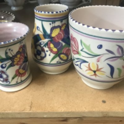 Three items of Poole pottery together with a ceramic vase lustre bowl and two glass vases .