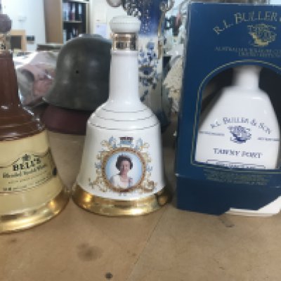 A bottle of Tawny port and two bells whisky decanters.