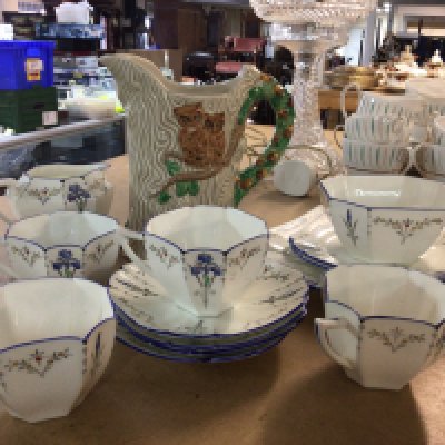 A part Shelley tea set together with a Clarice Cliff Newport Pottery jug in the form of a tree trunk decorated with owls, foliage and acorns