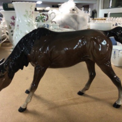 A Royal Doulton horse with its head down