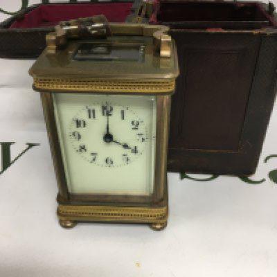 A brass carriage clock the dial with Arabic numerals fitted in original case .