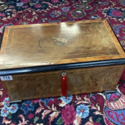 A Swiss cylinder musical box playing 8 airs as listed on tune sheet, marked Lith Picard - Lion, Geneve. 15 cm cylinder with 3 bell accompaniment. Brazilian Rosewood veneer to front and lid. Working condition. (D) 48cm x 27.5cm x 22cm.