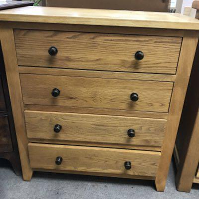 WITHDRAWN - A pine chest the regular top above four drawers .