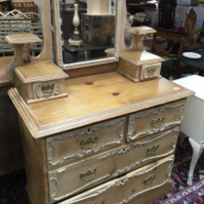 A pine dressing chest with applied mouldings raised mirror above two short a d two long drawers.