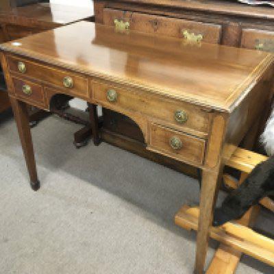 A 19th century mahogany and satinwood cross banded table fitted with four drawers on square tapering legs. NO RESERVE