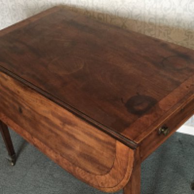 A George III mahogany Pembroke table the top with a wide cross banded edge on square legs. NO RESERVE