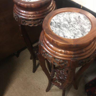 A pair of oriental wooden pedestals with marble tops, 82cm tall