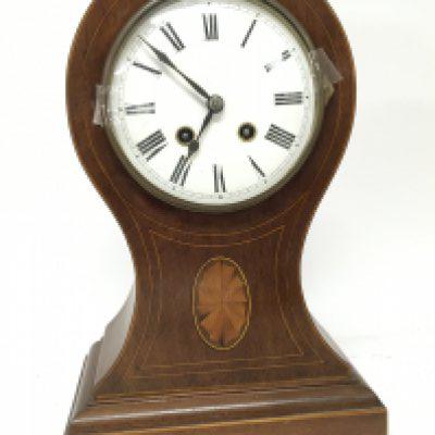 An Edwardian inlaid Mahogany mantel clock with balloon shaped case brass movement striking on a gong with pendulum height 35cm. NO RESERVE