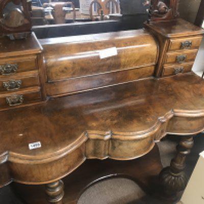 A walnut dressing table with swing mirror fitted with six small drawers.
