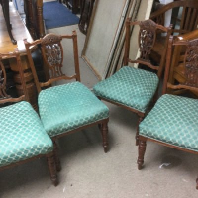 A set of four Edwardian chairs with carved backs. Shipping category D.
