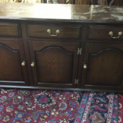 A oak sideboard fitted with three drawers and three cupboards under .