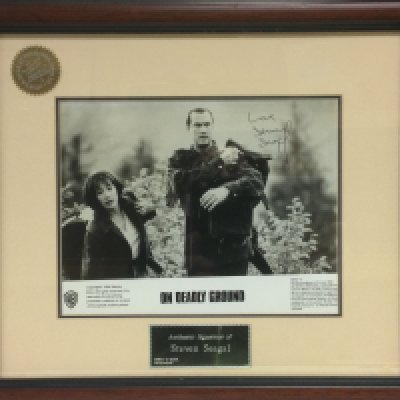 A framed and glazed signed lobby card by Steven Seagal for the film 'On Deadly Ground' with COA. Shipping category D. NO RESERVE