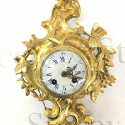 A 19th century French Ormolu cased wall clock by Japy Freres decorated with flowers, leaves a butterfly and bird surmount with eight day twin train brass movement.