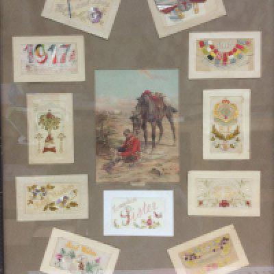 A framed and glazed collection of WW1 silk postcards. Shipping category D.