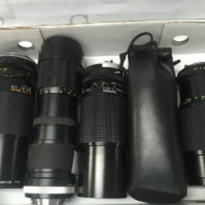Four various camera lenses including Vivitar 200mm, Tamron 210mm, Panagor 205mm. Postage category B