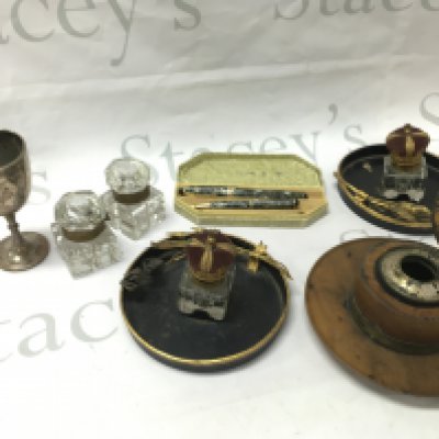 A wooden inkwell, two pairs of inkwells, a hallmarked silver cup and two Unique pens . This lot cannot be posted