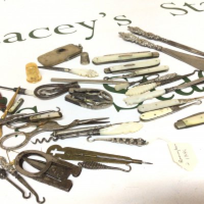 A collection of Victorian and later sewing implements mother of pearl and silver button hooks small folding knives silver handled button hooks and other assorted sewing items.