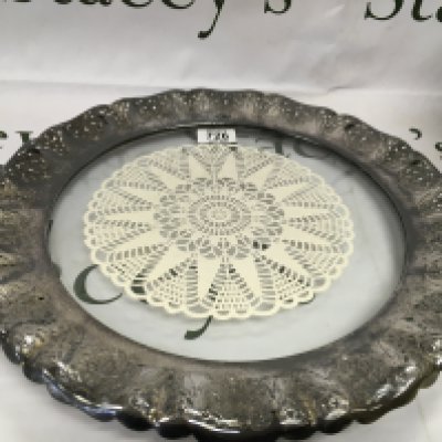 A glass tray with a silver plate rim.