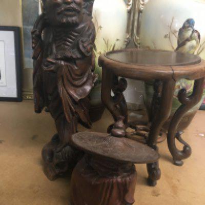 A Chinese root carving in the form of a elder a small stand and a jar and cover .
