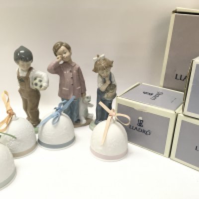 A Collection of boxed porcelain Lladro Christmas tree bell decorations and three porcelain Nao figures. This lot cannot be posted. NO RESERVE