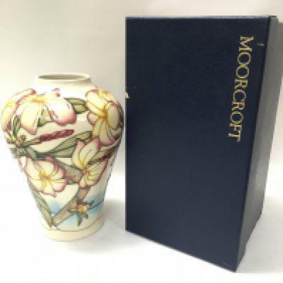 A boxed Moorcroft Frangipani vase, 22cm tall. No obvious large damage or restoration. This lot cannot be posted. NO RESERVE