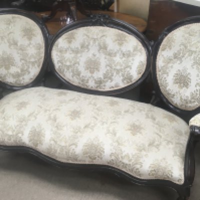 A double ended Victorian sofa with upholstered back and seat on cabriole legs .