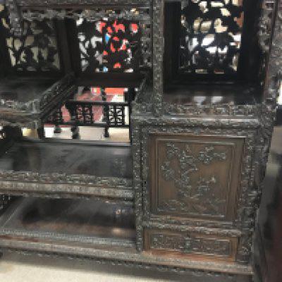 A Chinese display cabinet profusely carved with open sections single cupboard door and drawer on ball a claw feet . 104 x 220 cm