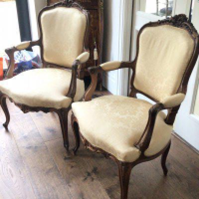 A pair of quality French Louis XVI style carved wood open arm chairs the top rail with folate scrolls upholstered in yellow floral fabric (sold in situ delivery by appointment)