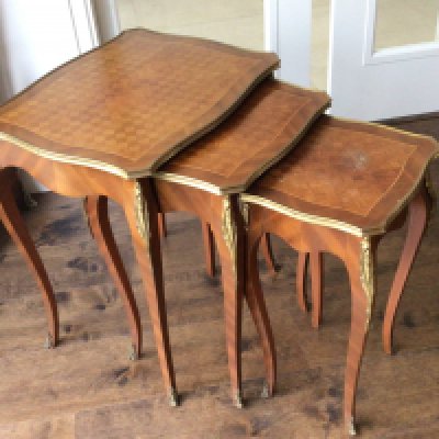 A Nest of three French Louis XV style walnut and parquetry tables with gilt metal mounts. Sold in situ collection by appointment.