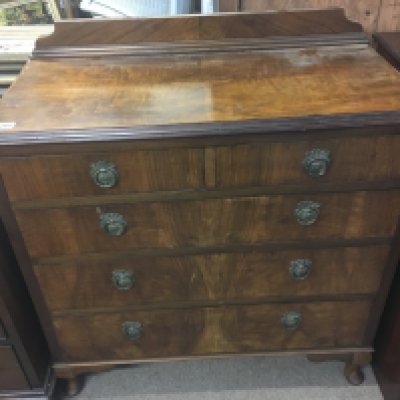 A walnut chest of drawers fitted with two short and three long drawers on small feet. NO RESERVE