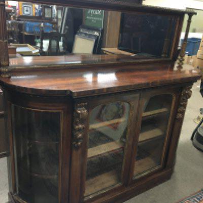 A Quality Early Victorian Walnut credenza with a raised mirrored back with gilded pillar supports above glazed doors with glazed bowed glass ends in very good original condition.158cm long height 135cm 48cm deep.