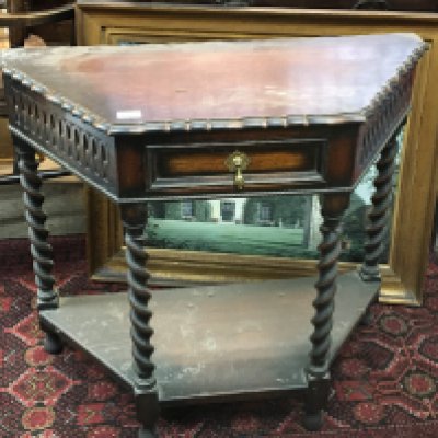 An oak side table with a shaped edge above a single drawer on barley twist legs united by an under shelf 85cm
